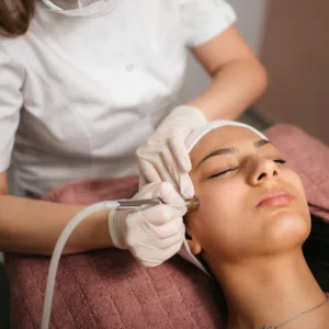 a woman getting a Microdermabrasion treatment on the face
